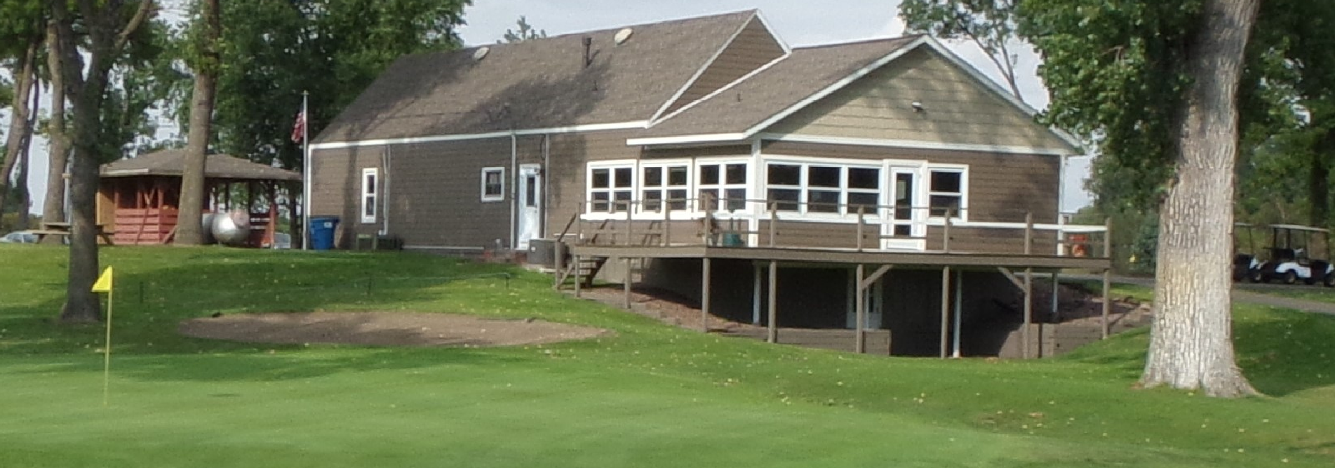 View of Winthrop Golf Club house from 9th hole green. Shows deck overlooking the 9th green.